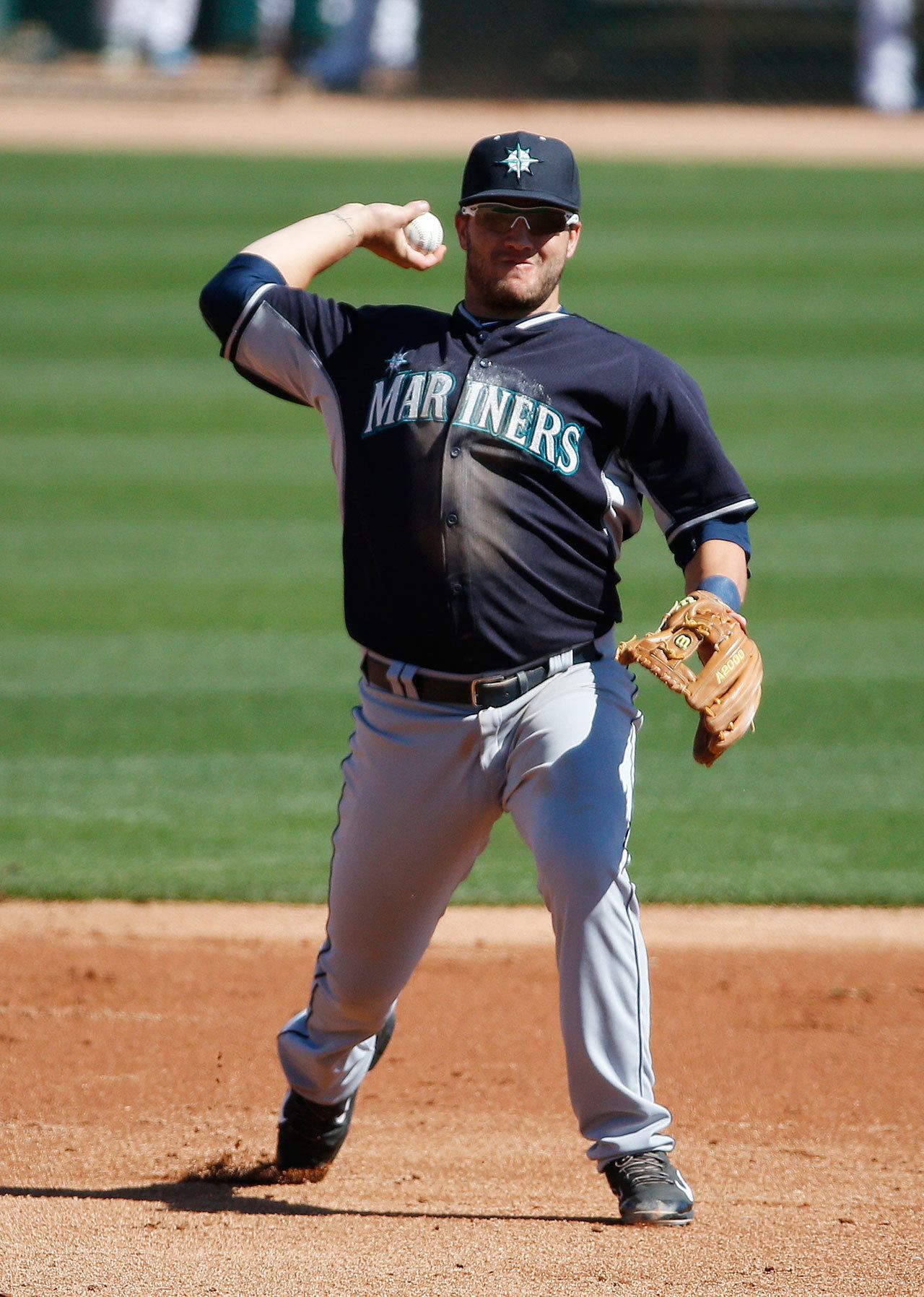 The Mariners’ D.J. Peterson throws to first base during the third inning of a spring training game against the Dodgers on March 6, 2015, in Phoenix. (AP Photo/John Locher)