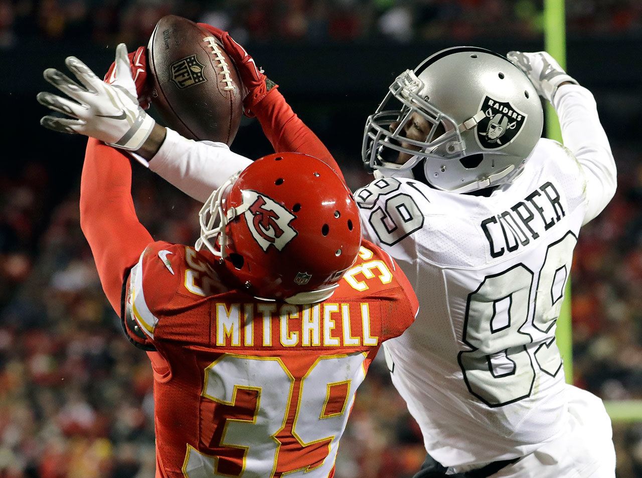 Chiefs defensive back Keith McGill II (39) nearly intercepts a pass intended for Raiders wide receiver Amari Cooper (89) during the first half of a game Thursday in Kansas City, Mo. (AP Photo/Charlie Riedel)
