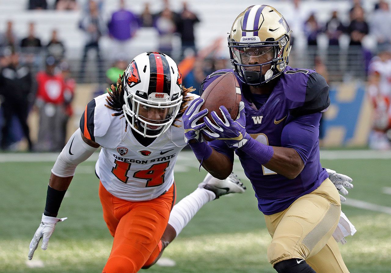 Washington’s John Ross (right) makes a long pass reception in front of Oregon State’s Treston Decoud during a game Oct. 22 in Seattle. Ross is the player of the year on the Associated Press All-Pac-12 team announced on Friday. (AP Photo/Elaine Thompson)