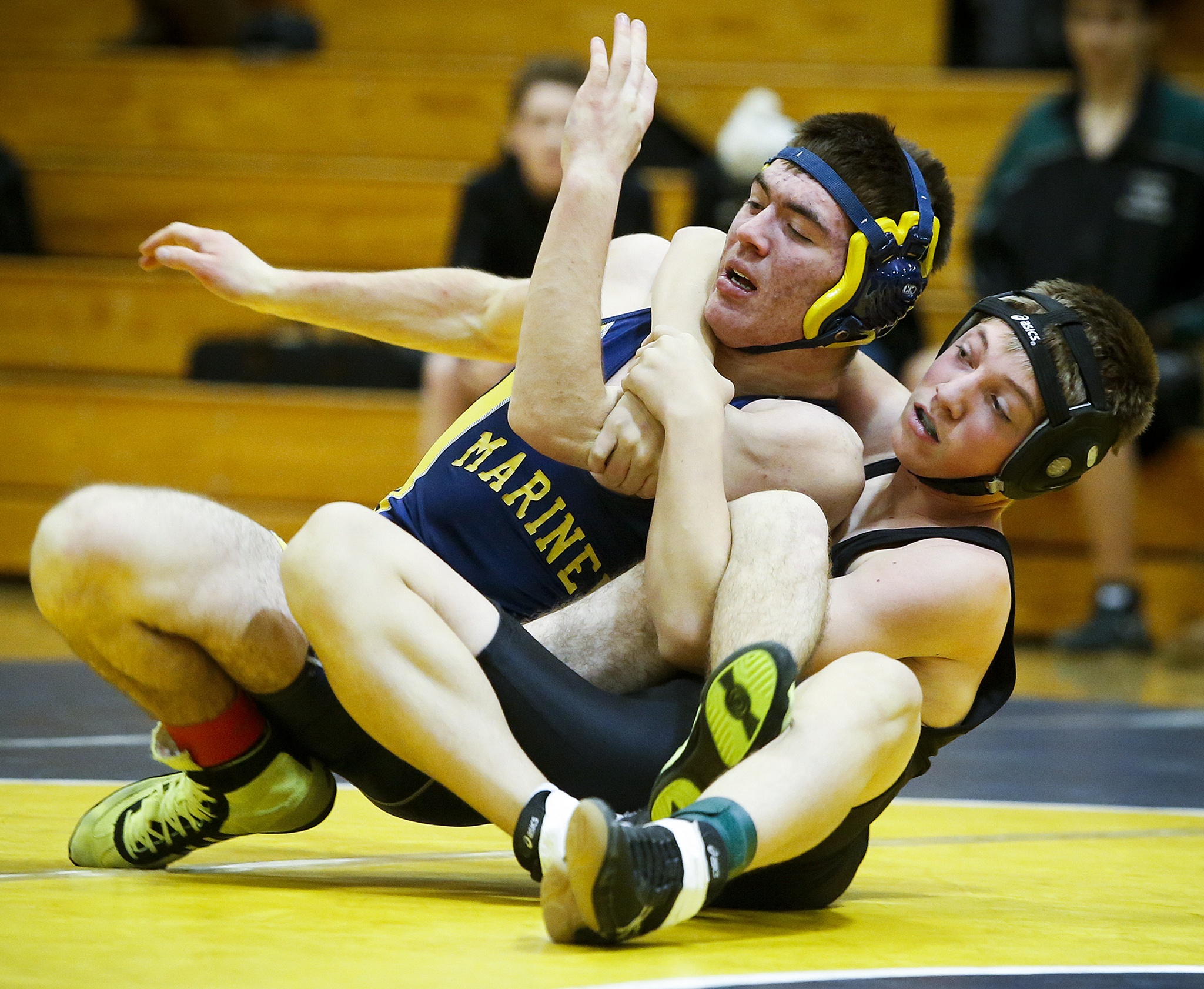 Jackson’s Xavier Wilkening (right) wraps up Mariner’s Thomas Gorrell on his way to winning his match at Mariner High School on Thursday, Dec. 15. (Ian Terry / The Herald)