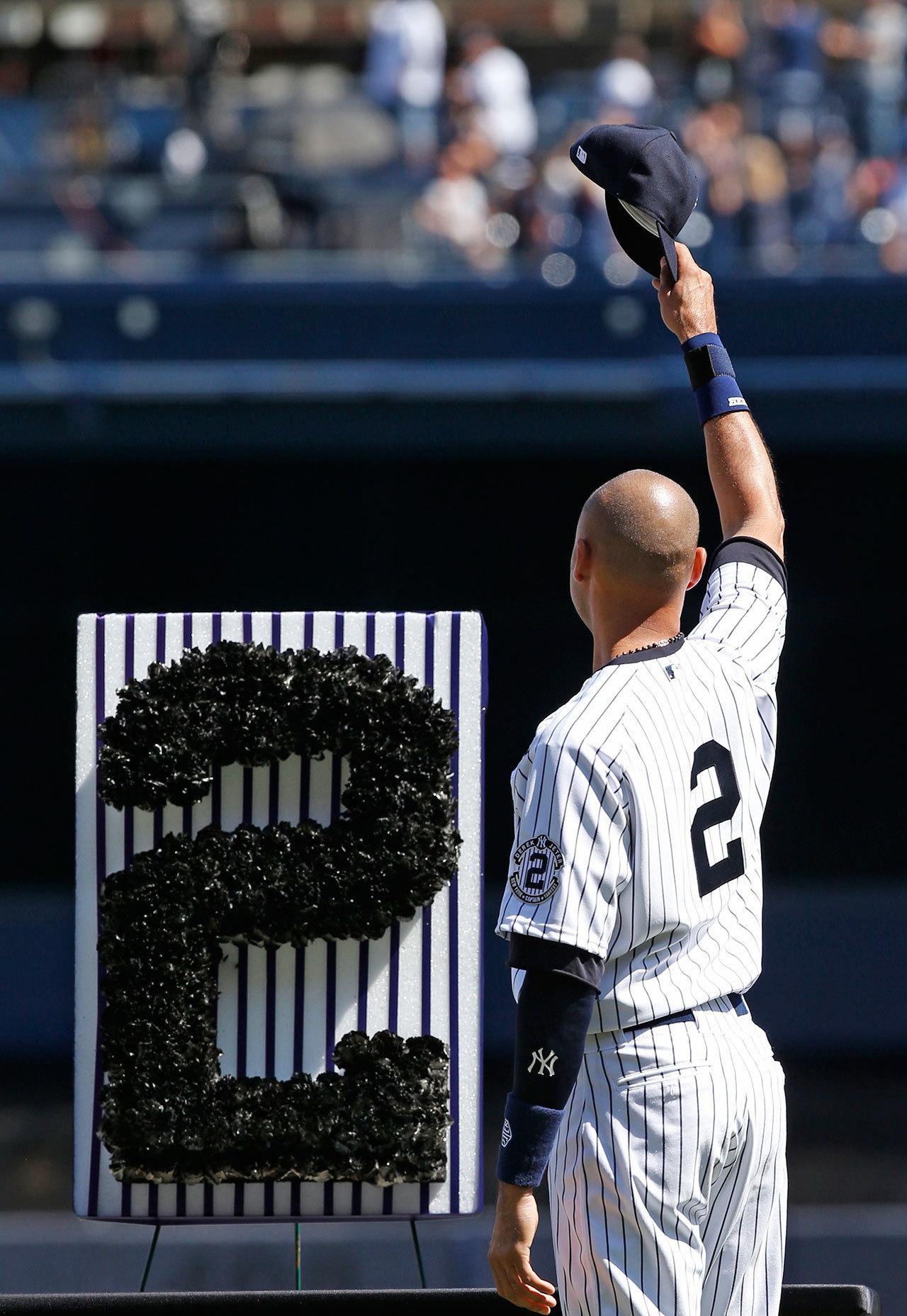 Derek Jeter (2) waves to fans during a pregame ceremony honoring the Yankees captain on Sept. 7, 2014, at Yankee Stadium in New York. (AP Photo/Kathy Willens, File)