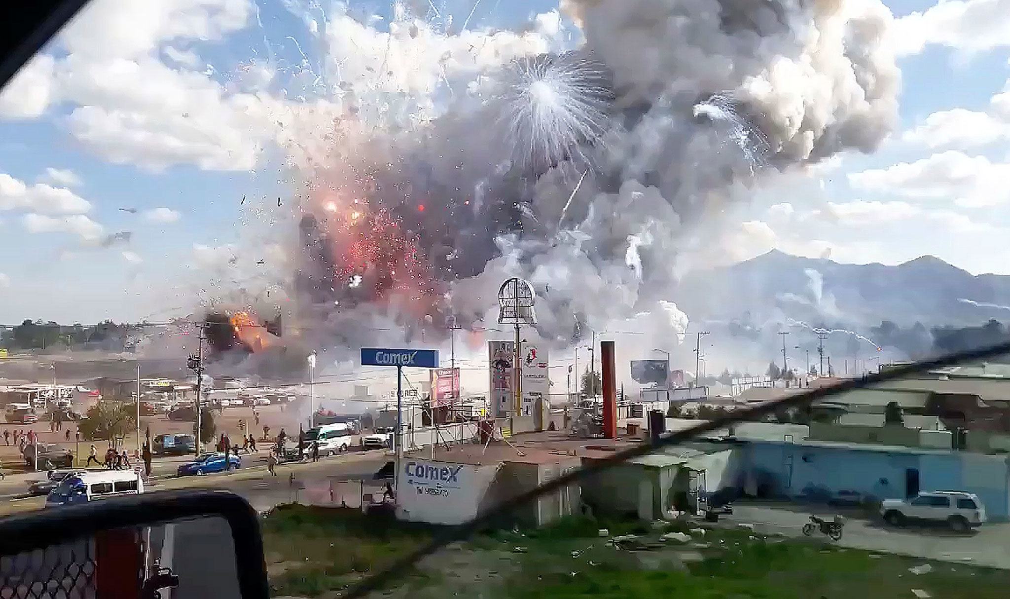 This image made from video recorded from a passing car shows an explosion ripping through the San Pablito fireworks market in Tultepec, Mexico, on Tuesday. (Jose Luis Tolentino via AP)