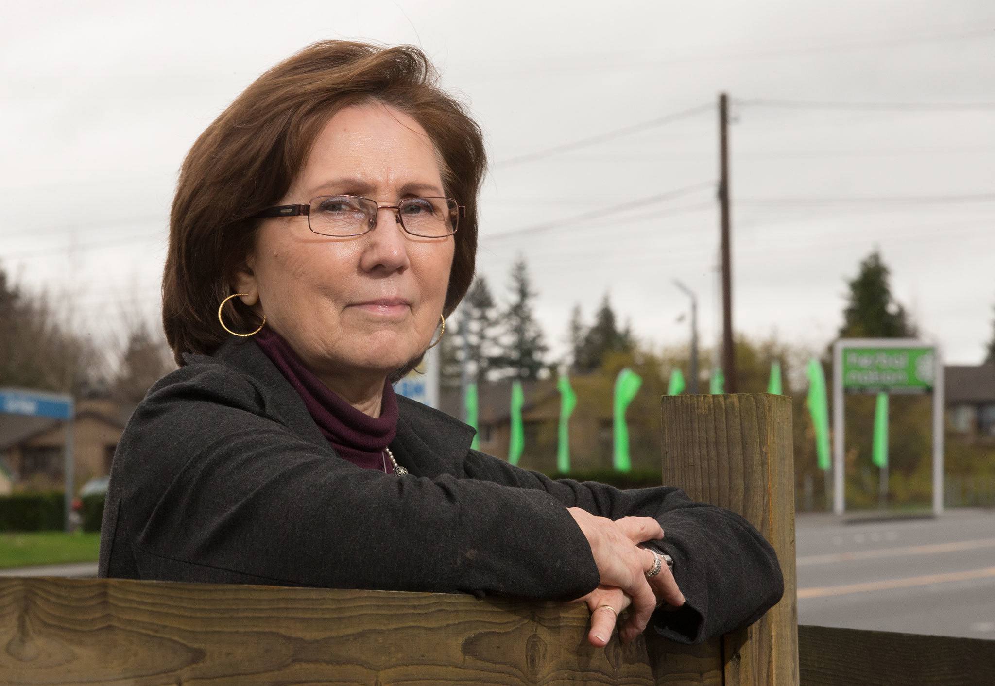 Diane Symms, owner of Lombardi’s, can walk less than 400 feet north or south of her restaurant in Bothell and run into a marijuana store, like Herbal Nation, visible by green flags and a neon sign. (Andy Bronson / The Herald)