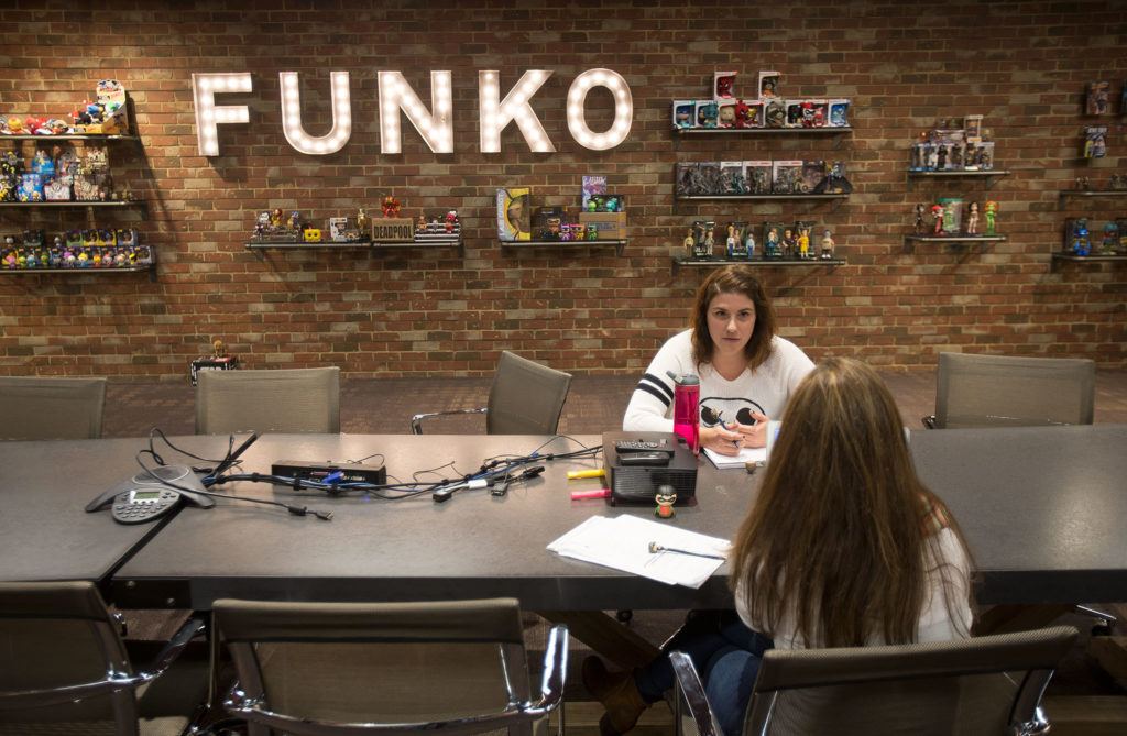 Product development manager Corinne Cavalaro, facing, and product manager Stephanie Sisolak talk in the conference room at Funko, a pop culture and licensed-focused collectibles company. (Andy Bronson / The Herald)
