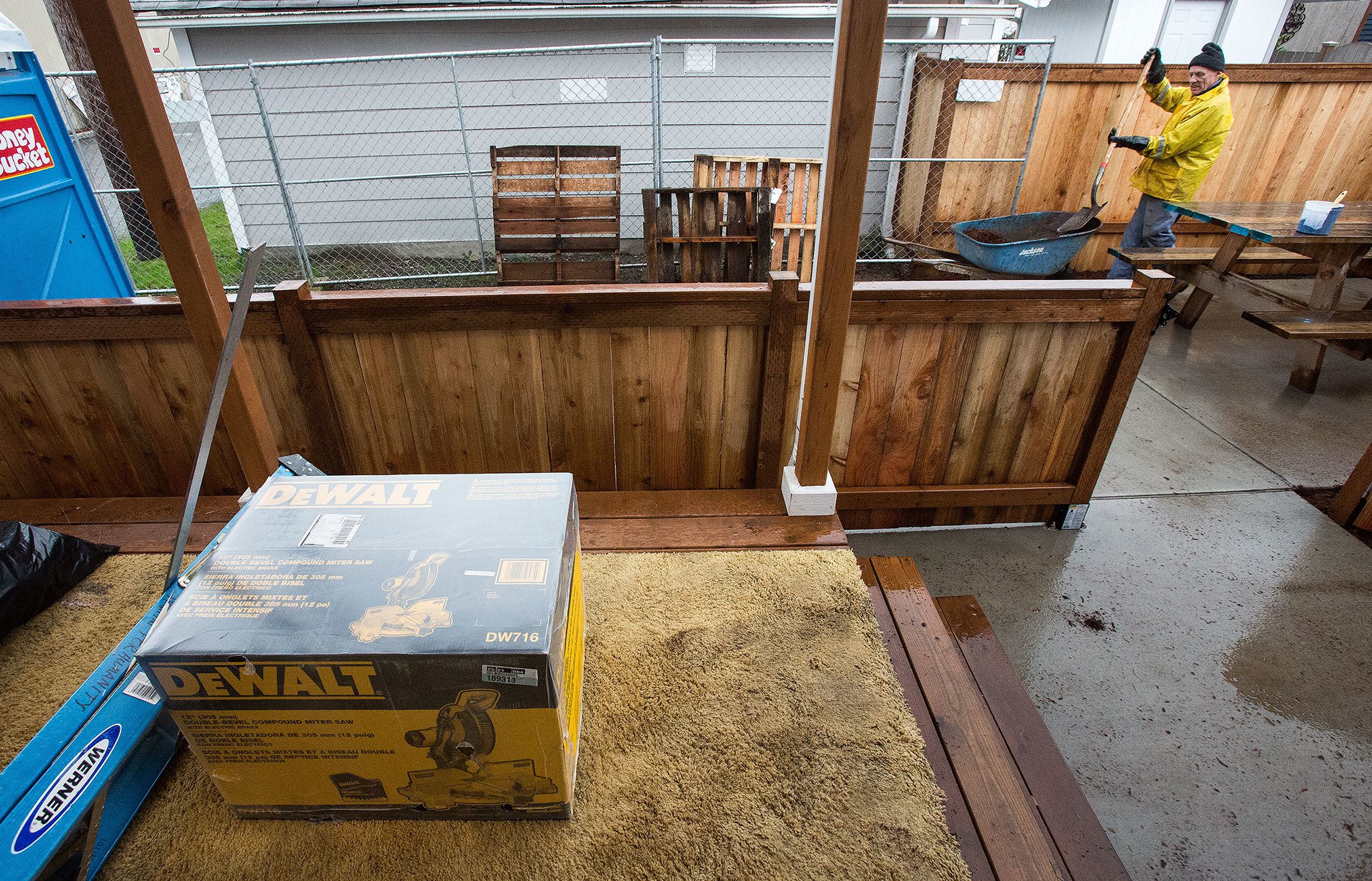 A donated miter saw sits on the back porch as Habitat For Humanity volunteer Jim Andringa lays down bark at a home on 23rd Street on Wednesday. Donations of new and used equipment are helping the volunteers after thousands of dollars of equipment was stolen from the group. (Andy Bronson / The Herald)