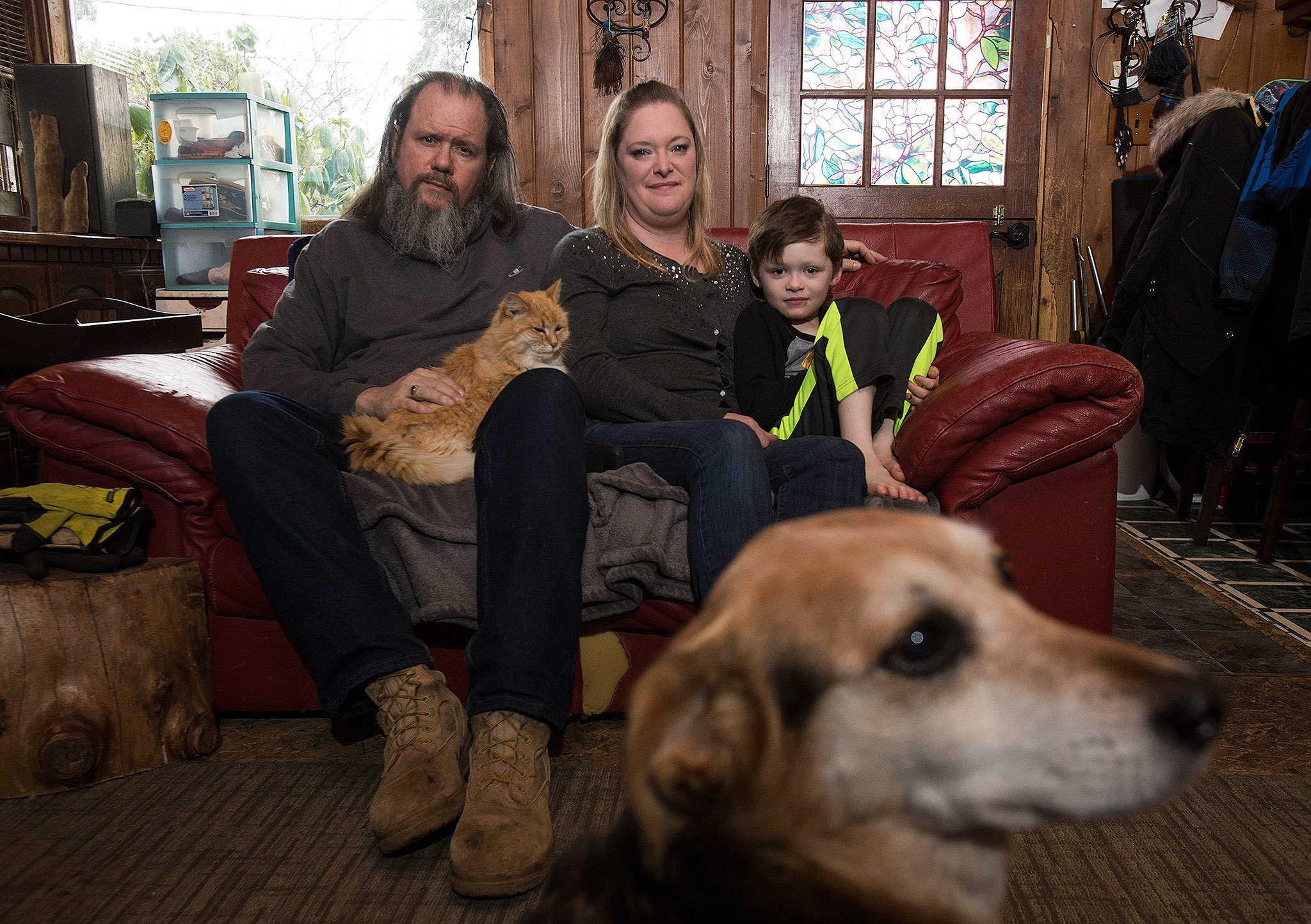 Victoria Troupe, her husband, Sean, and their son Henry have been living at her mother’s Everett home since being displaced by a fire at the Bluffs a year ago. Their cat Nova and dog Maggie are two of the pets the family lives with. (Andy Bronson / The Herald)