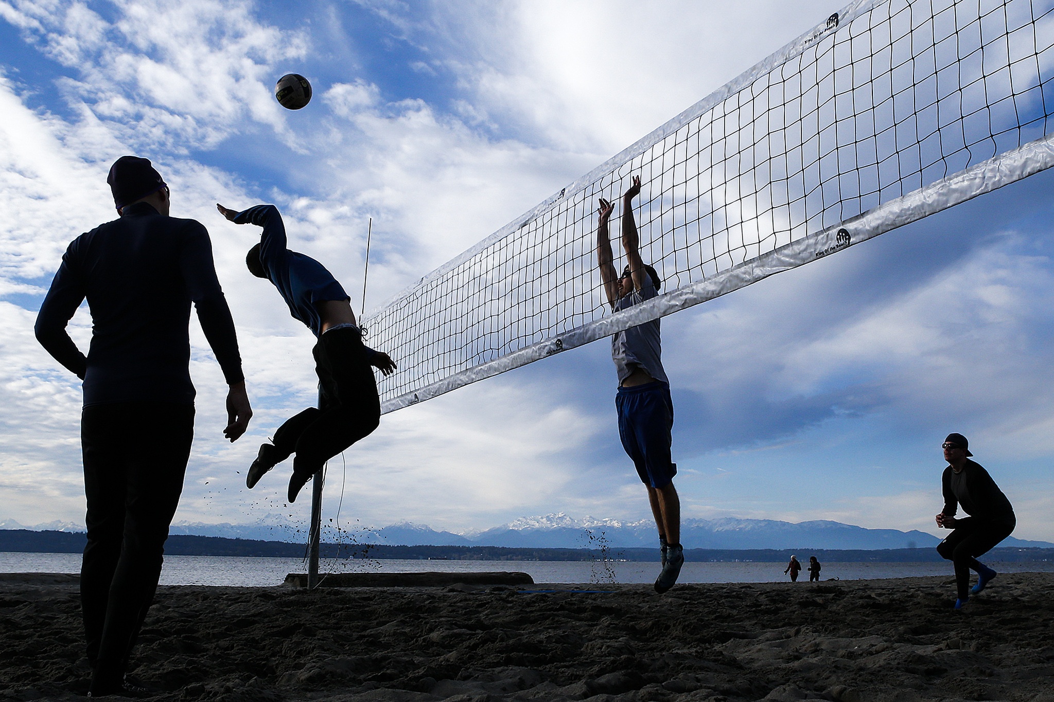 A mid-winter volleyball game breaks out at Golden Gardens Park on Ballard’s waterfront in Seattle on Thursday, Dec. 8. (Ian Terry / The Herald)