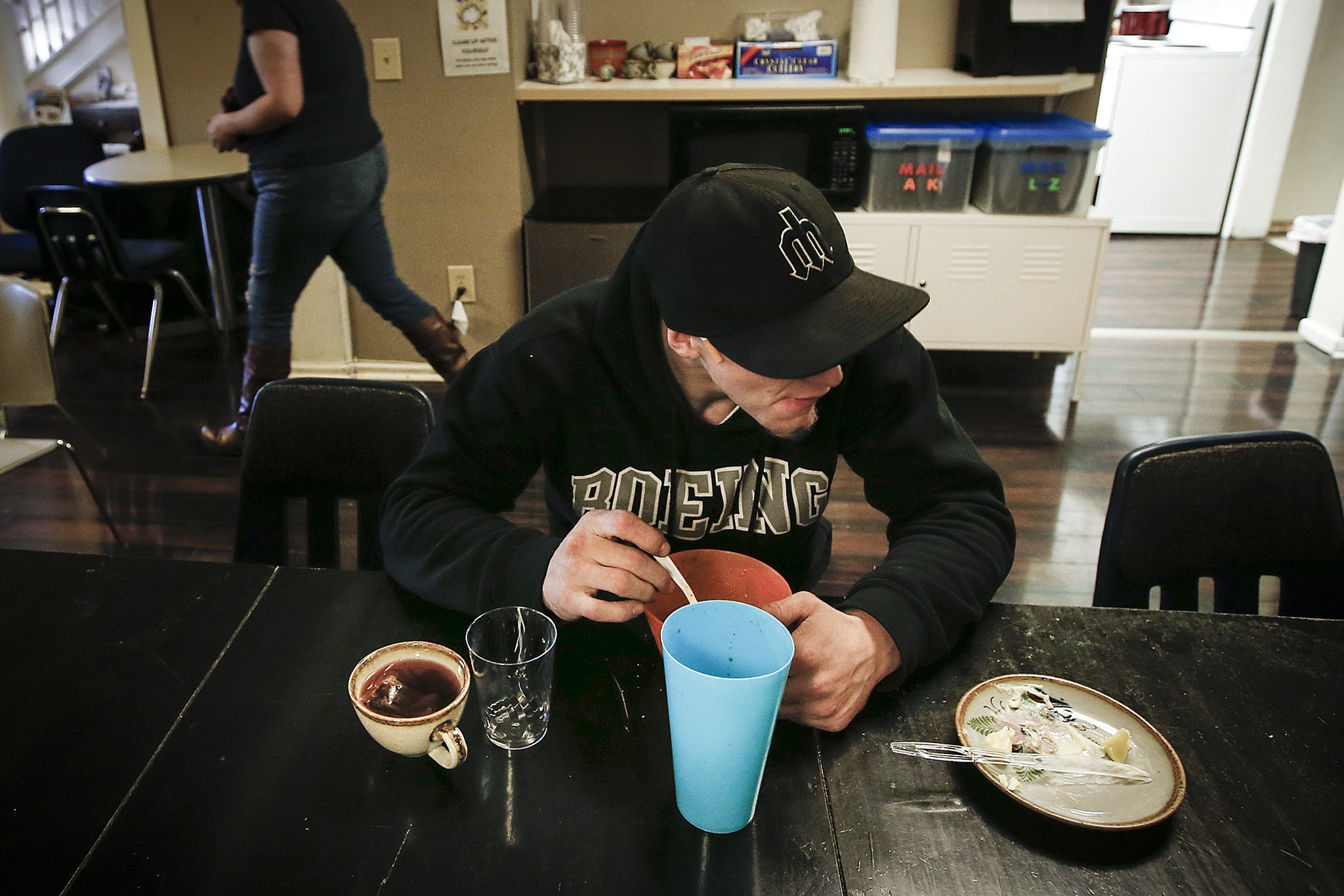 A visitor to Cocoon House’s U-Turn drop-in center on Broadway in Everett eats a warm meal on Tuesday, Dec. 13. The nonprofit that provides shelter and other services to at-risk youth is planning a major expansion and is slated to move into a new building on Colby Avenue by mid-2018. (Ian Terry / The Herald)