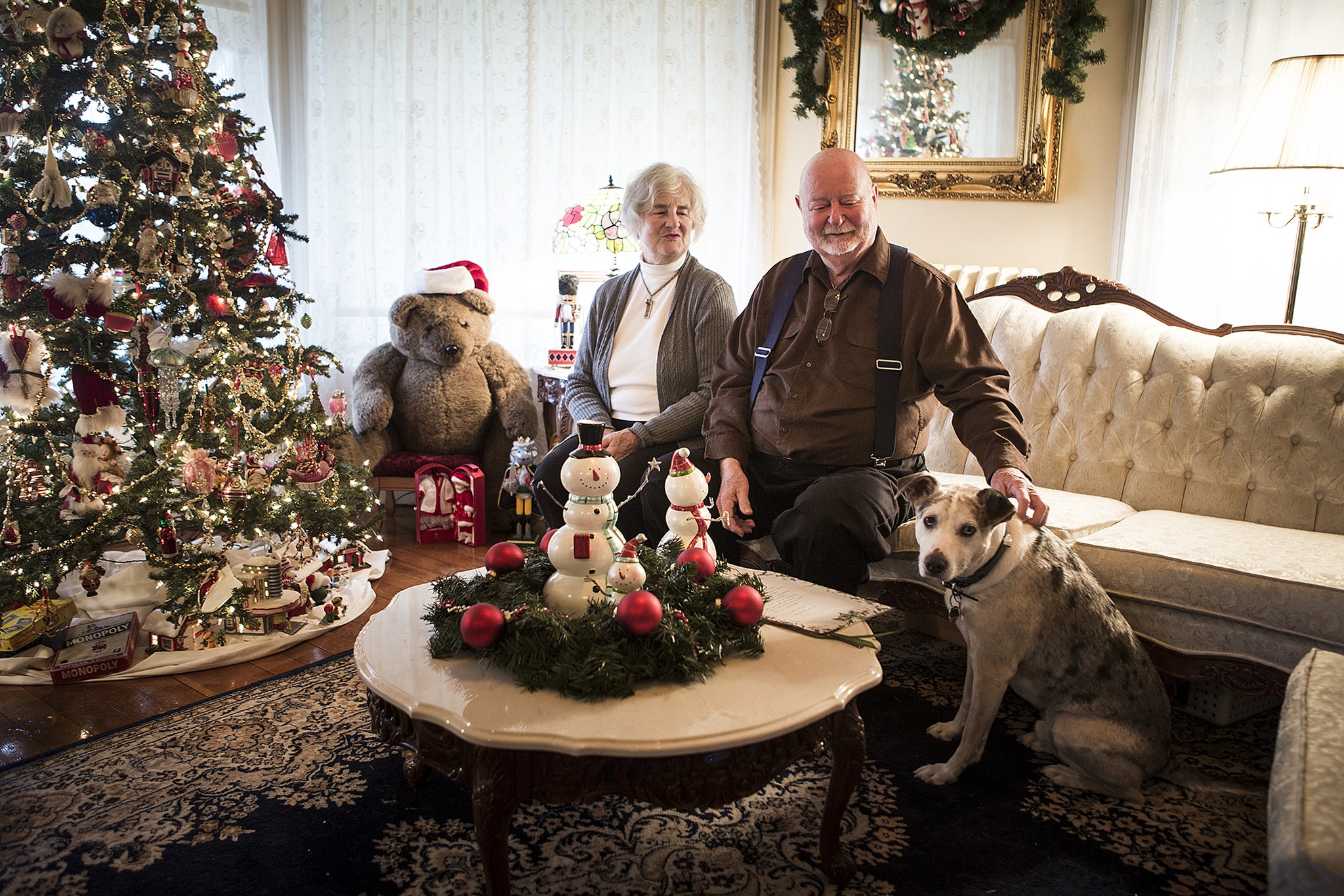 Lisa and Stew Pickford sit with Stryder, their Catahoula dog, in their home in Snohomish on Saturday, Dec. 3. The Pickford’s house, a Victorian home built in 1890, will be featured in this year’s 26th annual Christmas Parlor Tour hosted by The Snohomish Historical Society. (Ian Terry / The Herald)