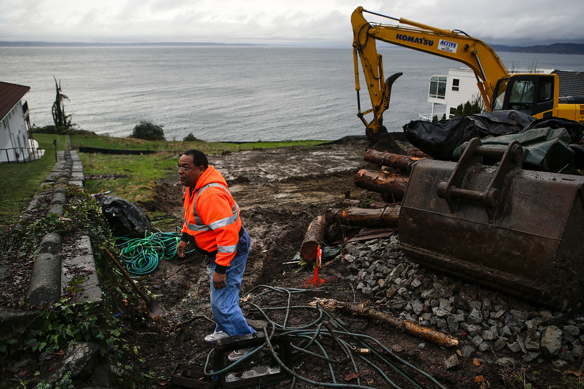 City of Edmonds worker Vince Smith stands on a property being developed on a hillside along 75th Place West in Edmonds on Friday. (Ian Terry / The Herald)