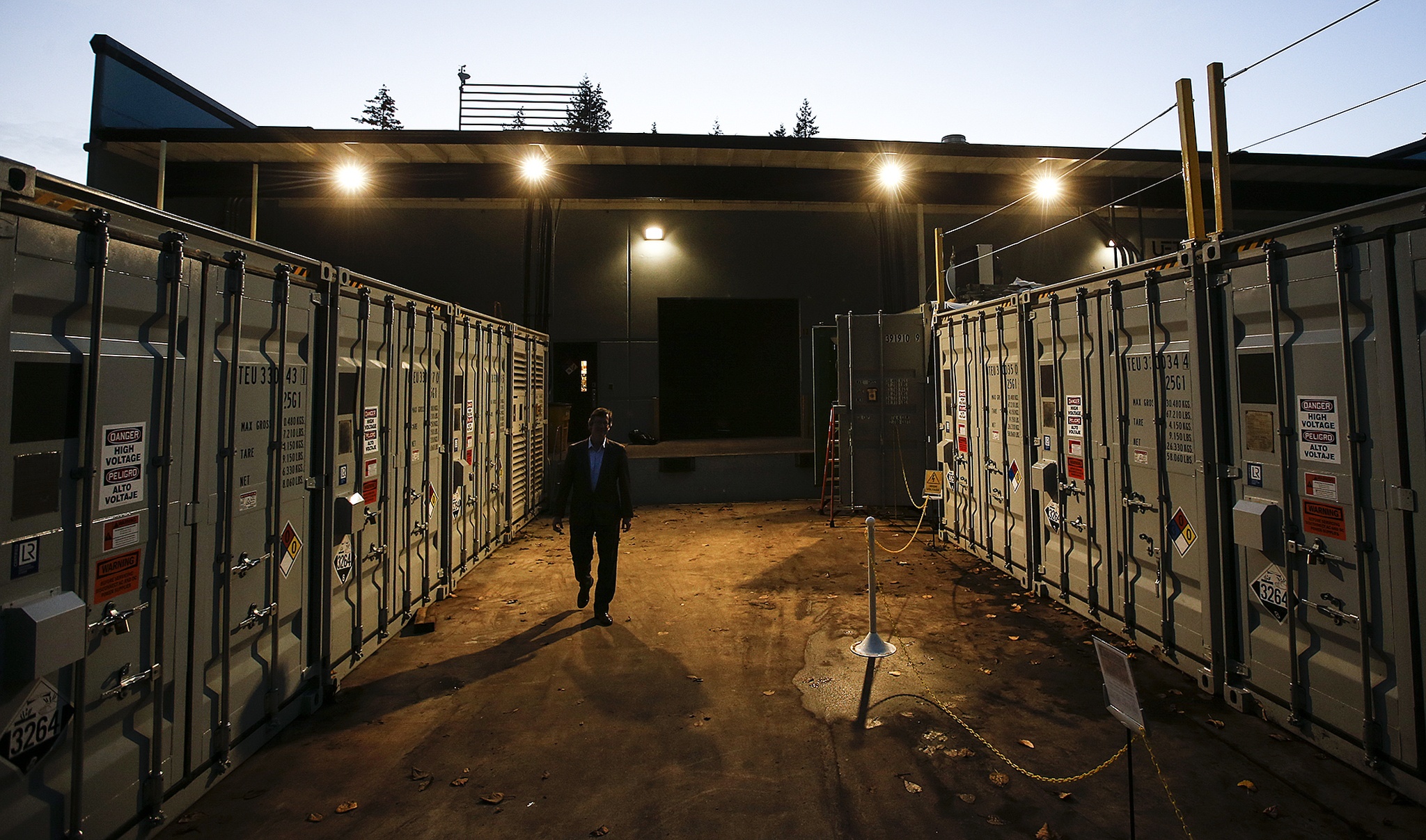 UniEnergy Technologies’ Russ Weed walks through a testing area for the Mukilteo-based company’s container size vanadium batteries Nov. 17. (Ian Terry / The Herald)