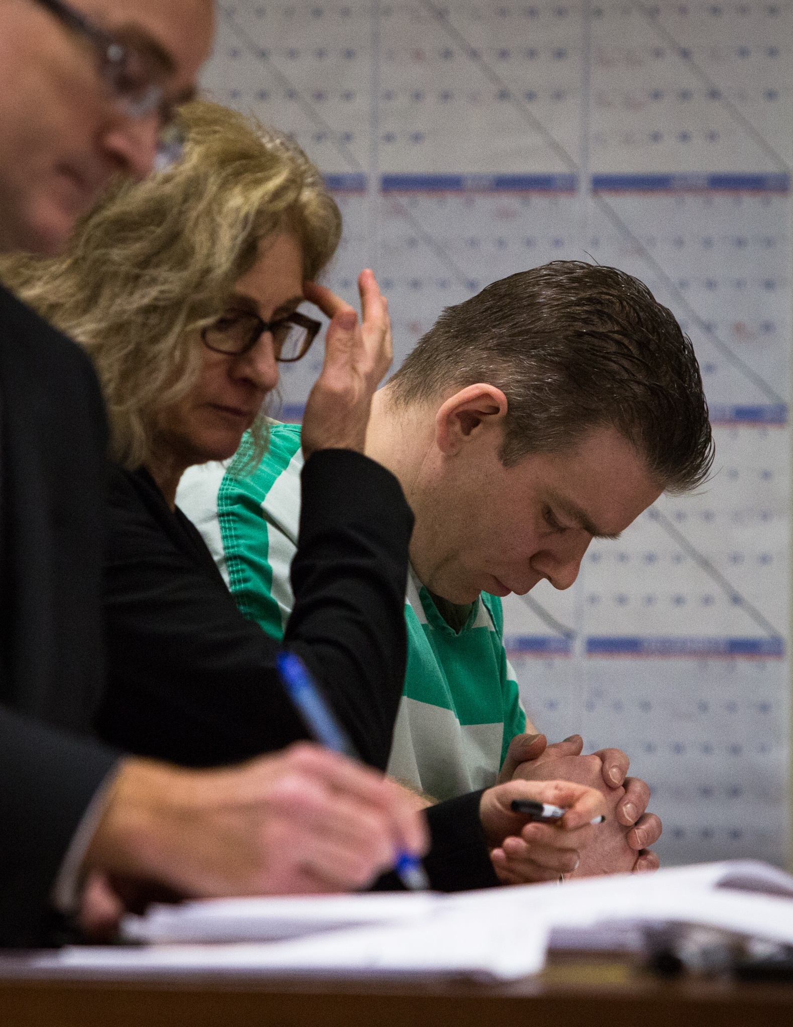 Tye Fleischer bows his head during his sentencing at the Snohomish County Court in Everett on Monday. Fleischer was sentenced to life in prison without parole after murdering two and injuring one last year. (Daniella Beccaria /The Herald)