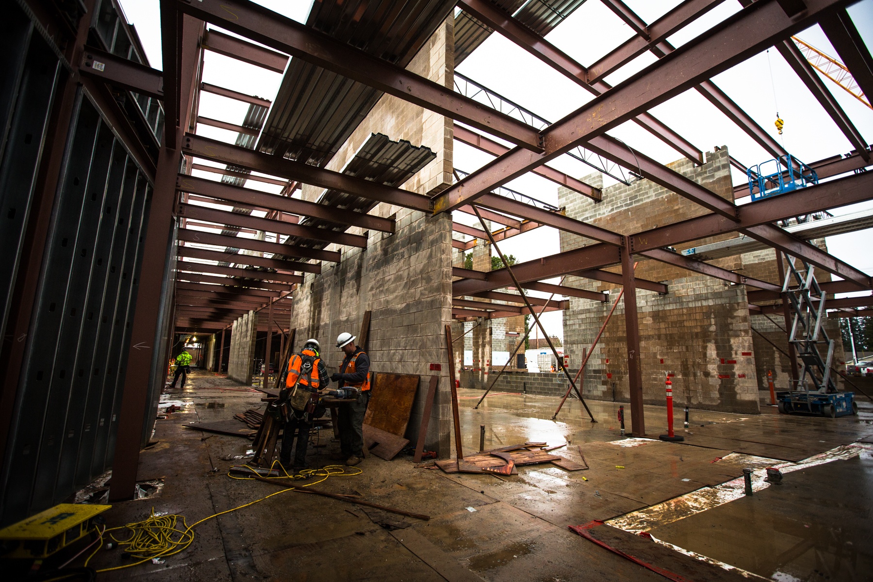 Construction crews work in what will be the main hallway of the two-story building filled with classrooms at Park Place Middle School on Monday in Monroe. The project is currently in its first phase and is set to be completed by 2018 with reconstruction of classrooms, fields, administration office, gymnasium and cafeteria. (Daniella Beccaria / The Herald)
