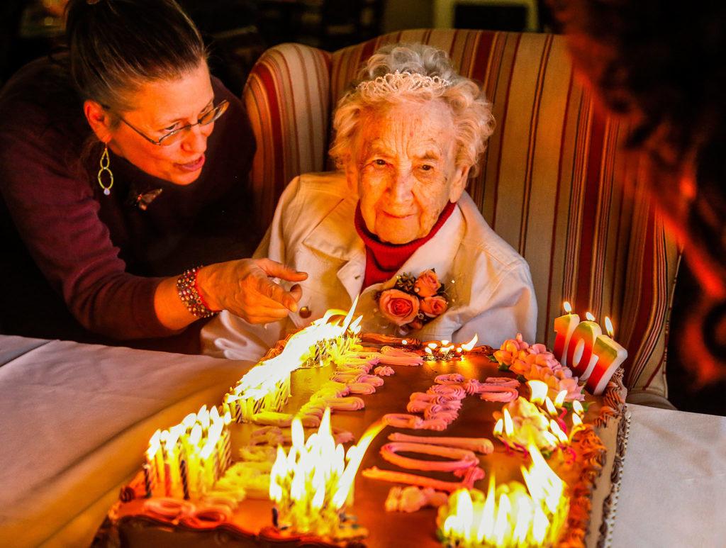 Caregiver Jamie Jedinak talks with Dillon during her party. (Dan Bates / The Herald)
