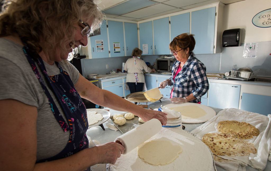 The potato balls are rolled out using a patterned rolling pin with a floured sock on it, then fried on a griddle. (Andy Bronson / The Herald)
