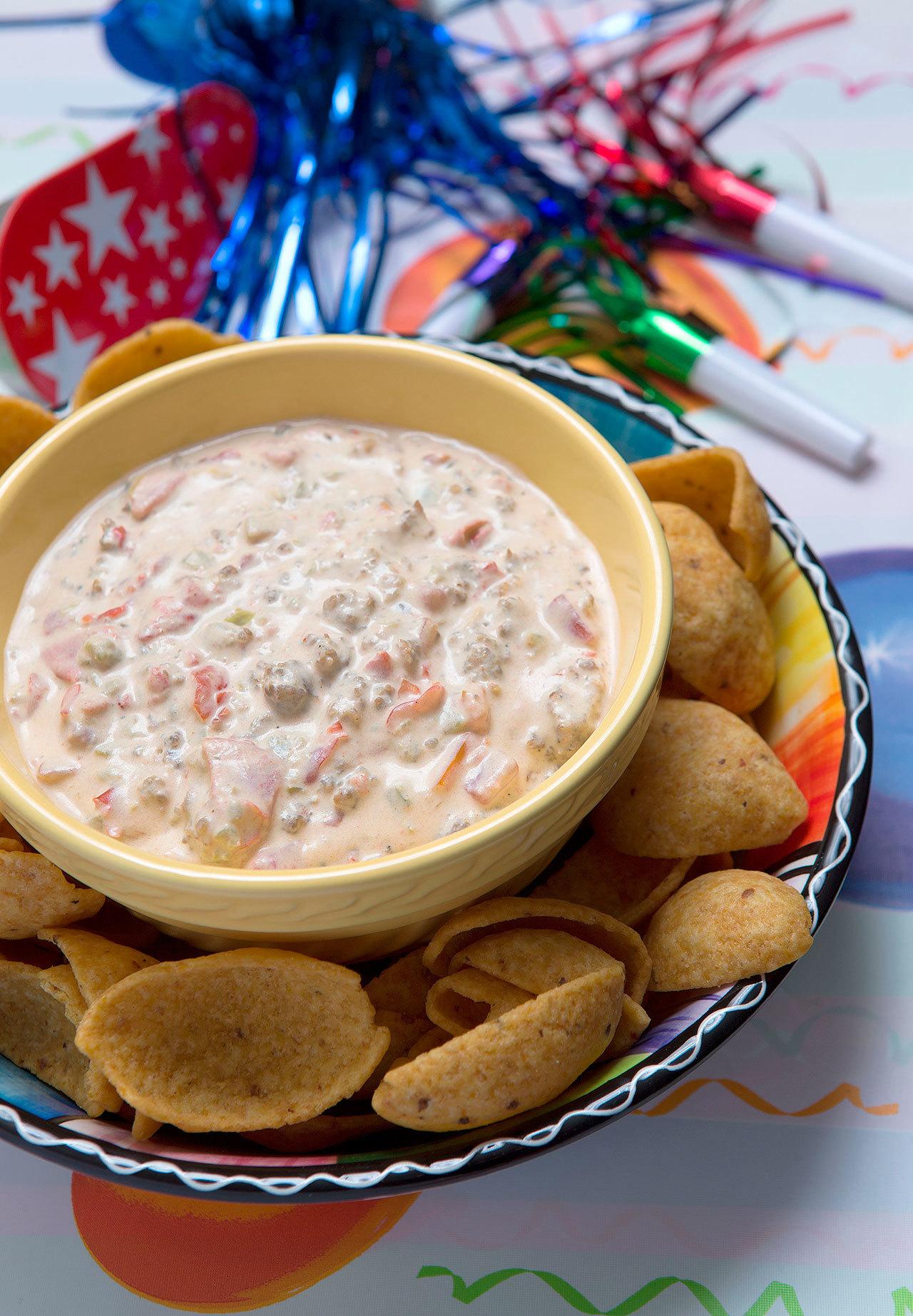 Spicy sausage dip is a great appetizer for any New Year’s Eve party. (Andy Bronson / The Herald)