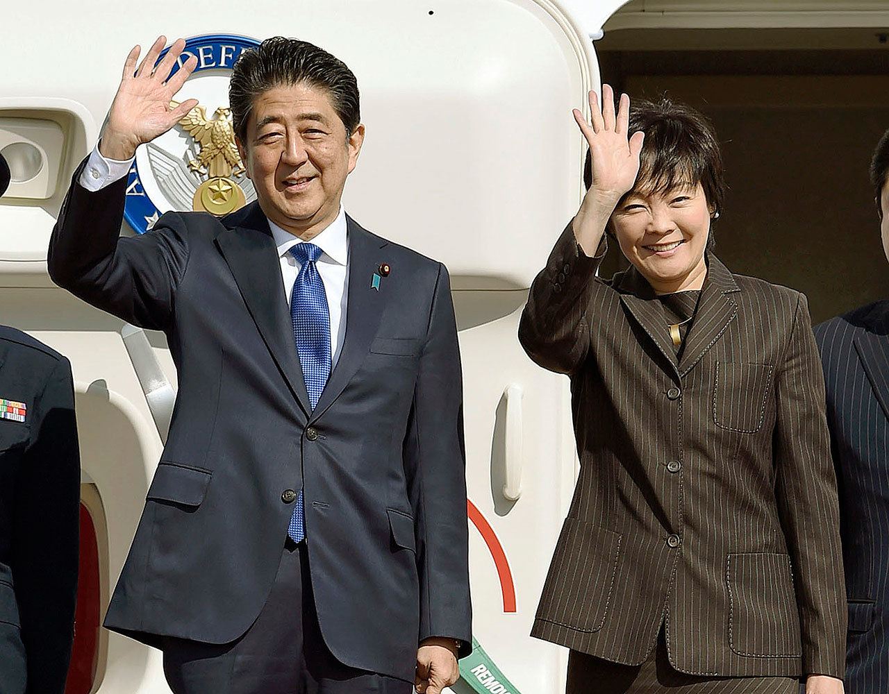 Japanese Prime Minister Shinzo Abe and his wife Akie wave prior to their departure to New York, at Haneda airport in Tokyo Thursday, Nov. 17, 2016. Abe plans to meet with President-elect Donald Trump on Thursday in New York. (Takuto Kaneko/Kyodo News via AP)