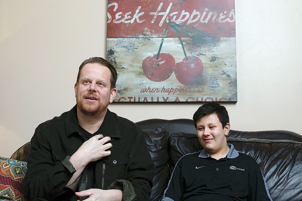 Brian Anaka (left) and his son, Taylor, at their home in Monroe. Brian was saved by CPR performed by Taylor. (Andy Bronson / Herald file)