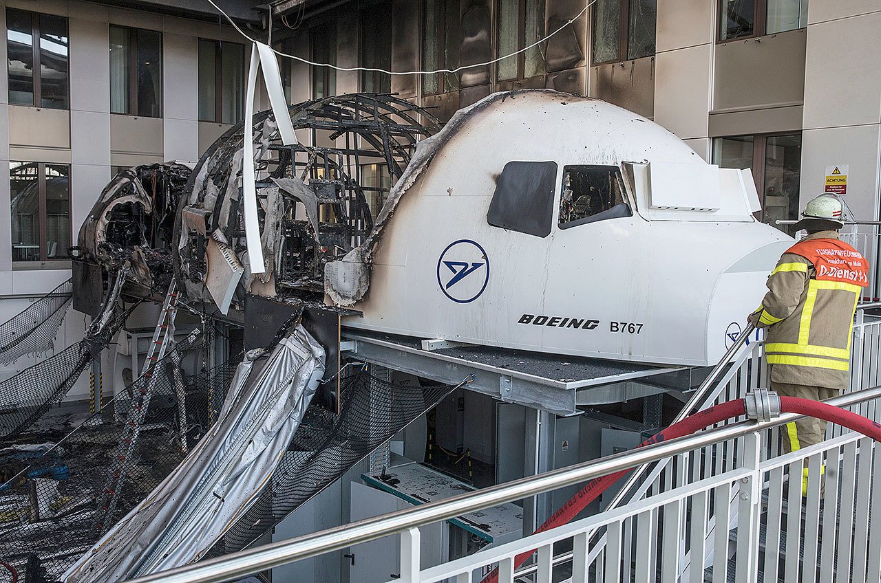 A firefighter stands in the office of Condor airlines next to a burned out Boeing 767 flight simulator at the airport in Frankfurt am Main, Germany, on Thursday. (Frank Rumpenhorst/dpa)