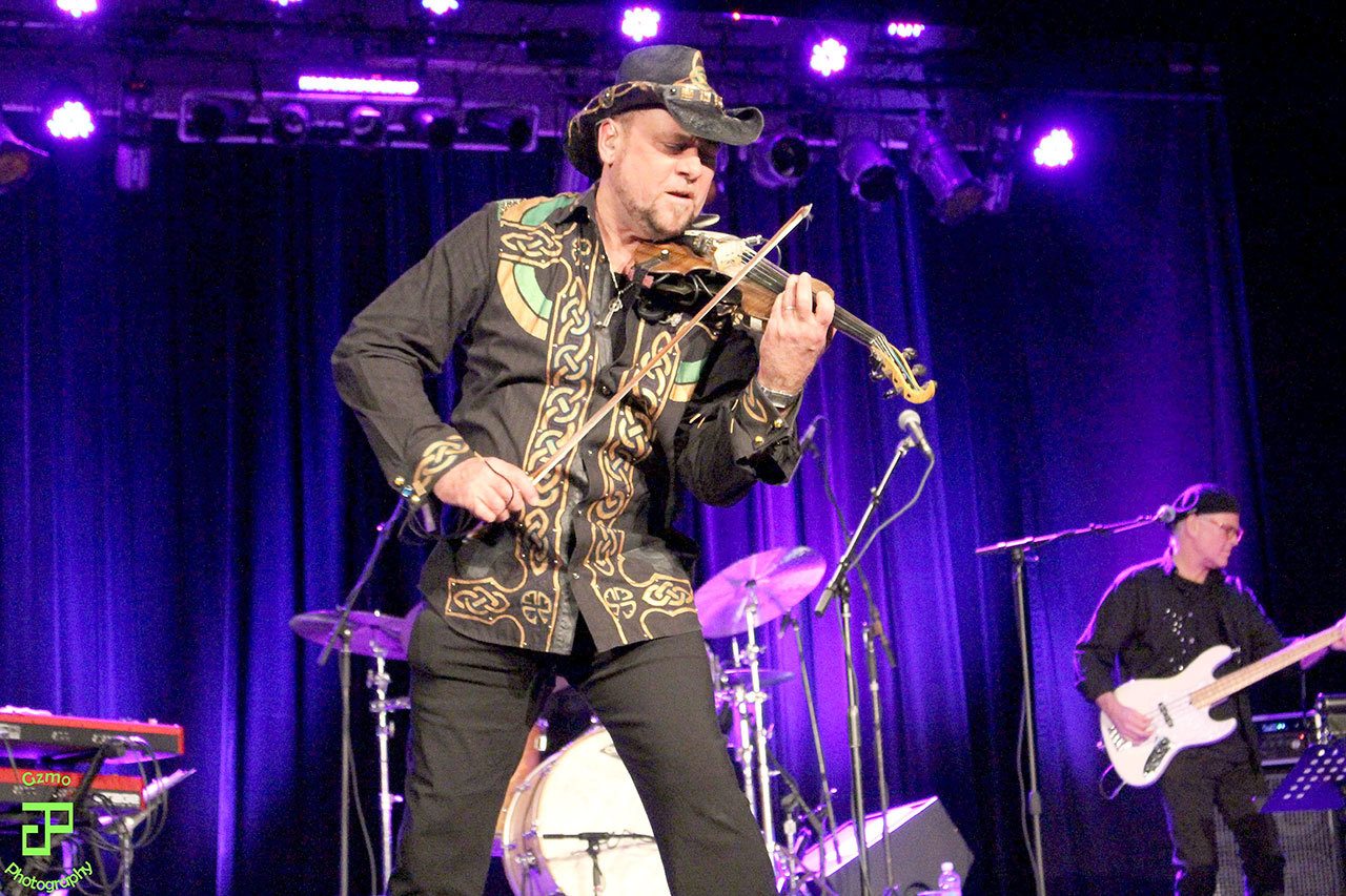 Geoffrey Castle plays his six-string electric violin in the 2015 version of Castle’s Celtic Christmas Concert, which will be performed again on Saturday at the Historic Everett Theatre. His shirt and hat are hand-painted by his wife, Shannon Castle.
