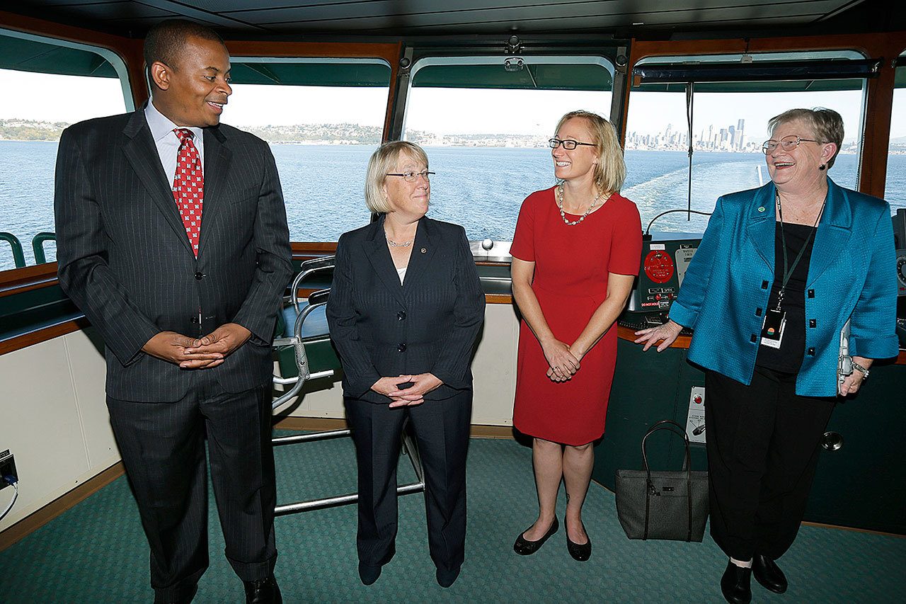 In this Oct. 6, 2014 photo, Lynne Griffith (right), assistant secretary for the Department of Transportation’s ferries division, talks with U.S. Department of Transportation Secretary Anthony Foxx (left), U.S. Sen. Patty Murray, D-Wash. (second from left) and Lynn Peterson (second from right), Washington state Secretary of Transportation, on a Washington state ferry traveling between Seattle and Bainbridge Island. The Washington Dept. of Transportation announced Monday, Dec. 5, that Griffith, who heads the ferries division, will be retiring in January, 2017. (AP Photo/Ted S. Warren)
