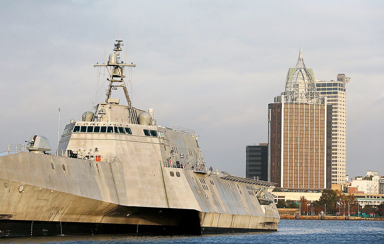 In this Nov. 30 photo, the city scape of Mobile, Alabama, is seen behind the docked USS Gabrielle Giffords, a Naval littoral combat ship built at the Austal USA shipyards on the Mobile River. The ship is named in honor of former U.S. Rep. Gabrielle “Gabby” Giffords of Arizona. (AP Photo/Brynn Anderson)