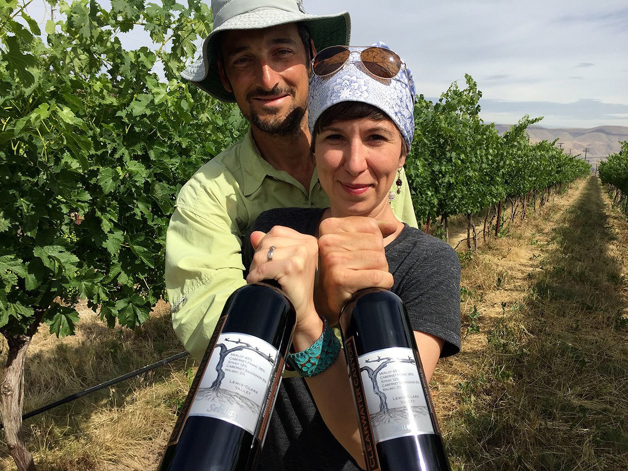 Karl and Coco Umiker stand in their Lewiston, Idaho, vineyard holding bottles of Clearwater Canyon Cellars 2013 Selway Red Wine, which won a double gold at the 2016 San Francisco International Wine Competition. (Photo by Eric Degerman/Great Northwest Wine)
