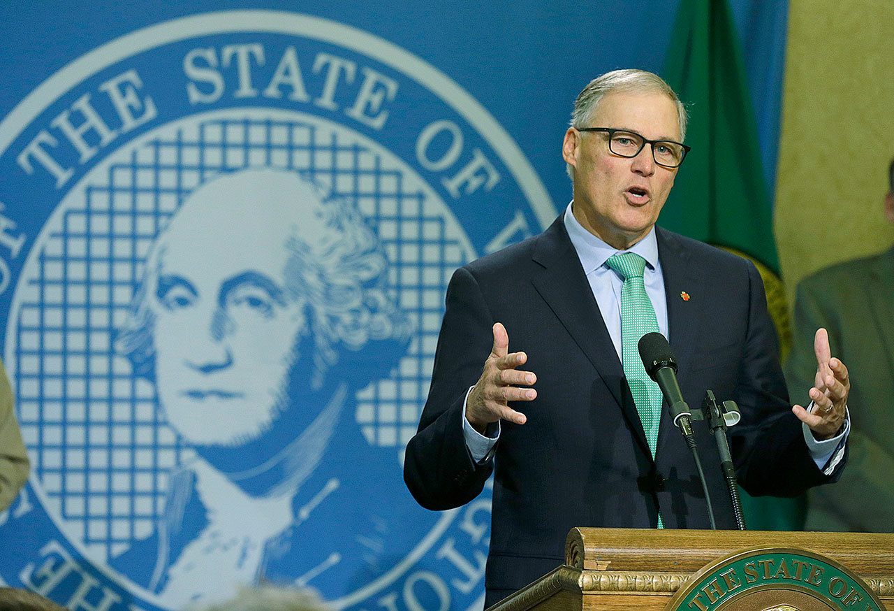 Washington Gov. Jay Inslee talks to reporters about his proposed budget on Wednesday in Olympia. (AP Photo/Ted S. Warren)