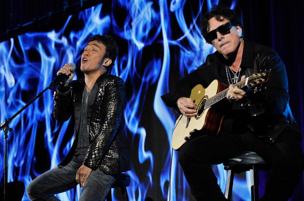 In this 2013 photo, Arnel Pineda (left) and Neal Schon of the rock band Journey perform onstage following a panel discussion on the Independent Lens documentary “Don’t Stop Believin’: Everyman’s Journey,” at the PBS Summer 2013 TCA press tour at the Beverly Hilton Hotel in Beverly Hills, California. (Photo by Chris Pizzello/Invision/AP, File)
