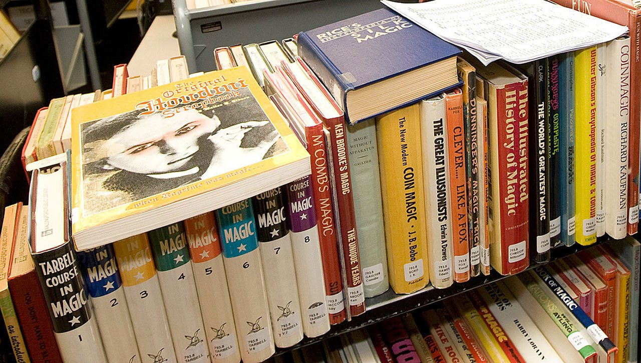 Library books sit on a cart to await processing. (Dave Zajac / Record-Journal)