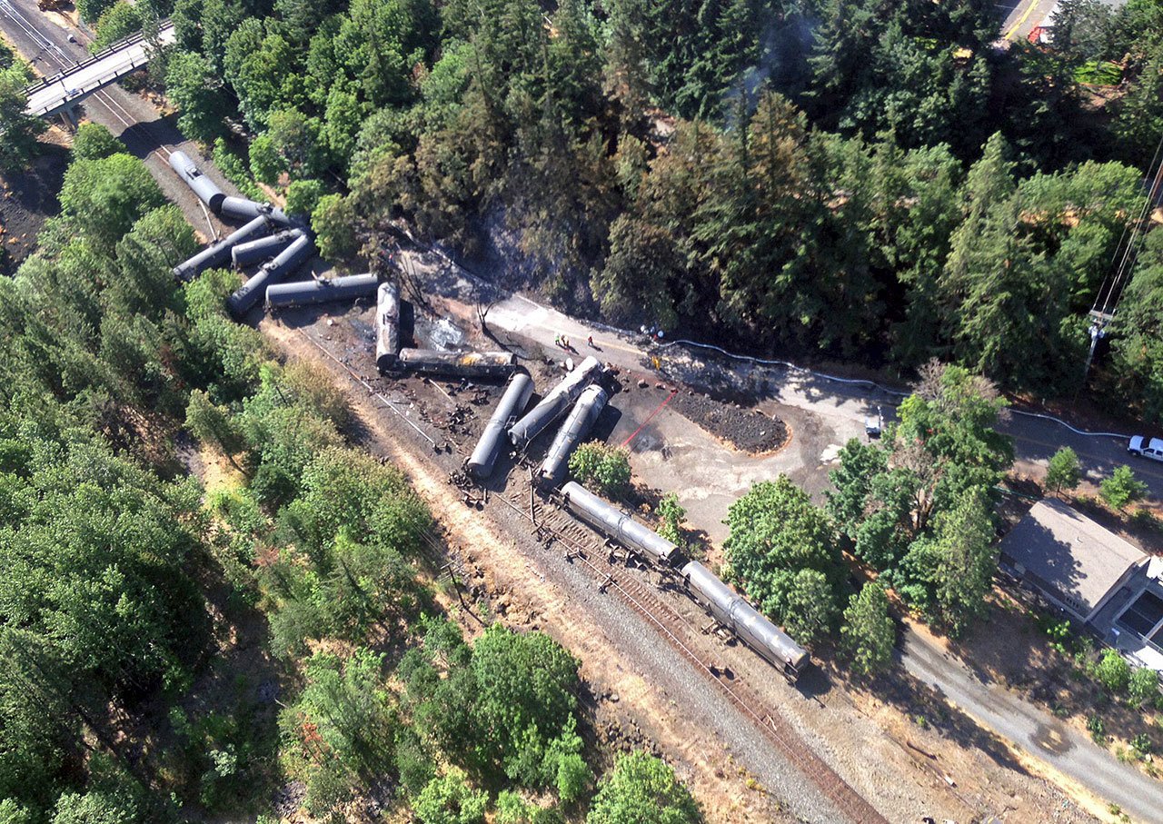 This June 4 aerial photo, provided by the Washington State Department of Ecology, shows scattered and burned oil tank cars after a train derailed near Mosier, Oregon. (Washington State Dept. of Ecology via AP, file)