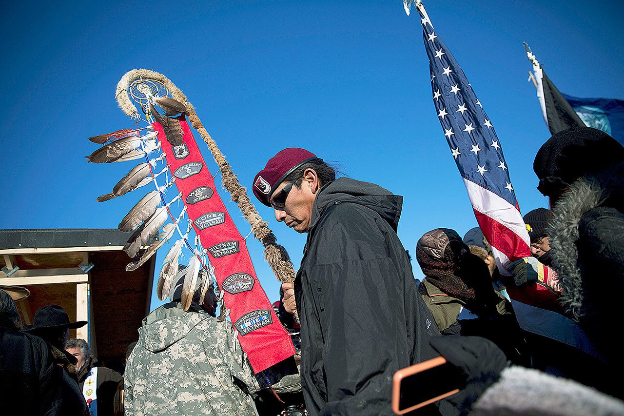 Native American veterans join an interfaith ceremony at the Oceti Sakowin camp where people have gathered to protest the Dakota Access oil pipeline in Cannon Ball, North Dakota, on Sunday, Dec. 4. (AP Photo/David Goldman)