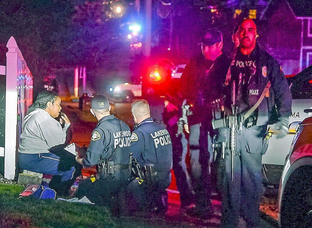 Police stand by a distraught Kristi Croskey at the scene where a Tacoma Police officer Reginald “Jake” Gutierrez was shot while responding to a domestic call in east Tacoma. (Peter Haley/The News Tribune via AP)
