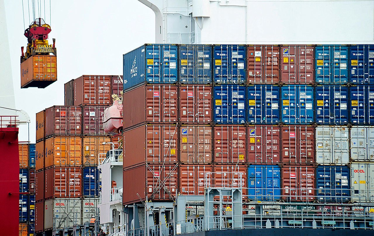 In this 2010 photo, a container is loaded onto a cargo ship at the Tianjin port in China. American consumers and businesses would pay, literally, if President-elect Donald Trump follows through on his campaign pledge to slap big taxes on imports from China and Mexico. (AP Photo/Andy Wong, File)
