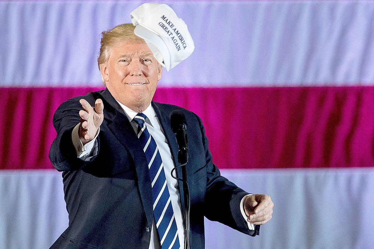 President-elect Donald Trump throws a hat into the audience while speaking at a rally in Baton Rouge, Louisiana, on Friday. (AP Photo/Andrew Harnik)