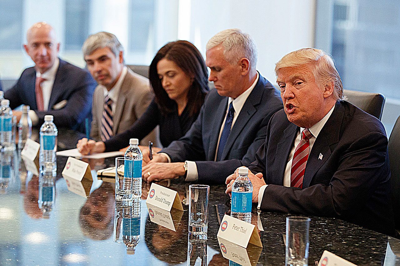 President-elect Donald Trump speaks during a meeting with technology industry leaders at Trump Tower in New York on Wednesday, Dec. 14. From left are Amazon founder Jeff Bezos, Alphabet CEO Larry Page, Facebook COO Sheryl Sandberg, Vice President-elect Mike Pence, and Trump. (AP Photo/Evan Vucci)