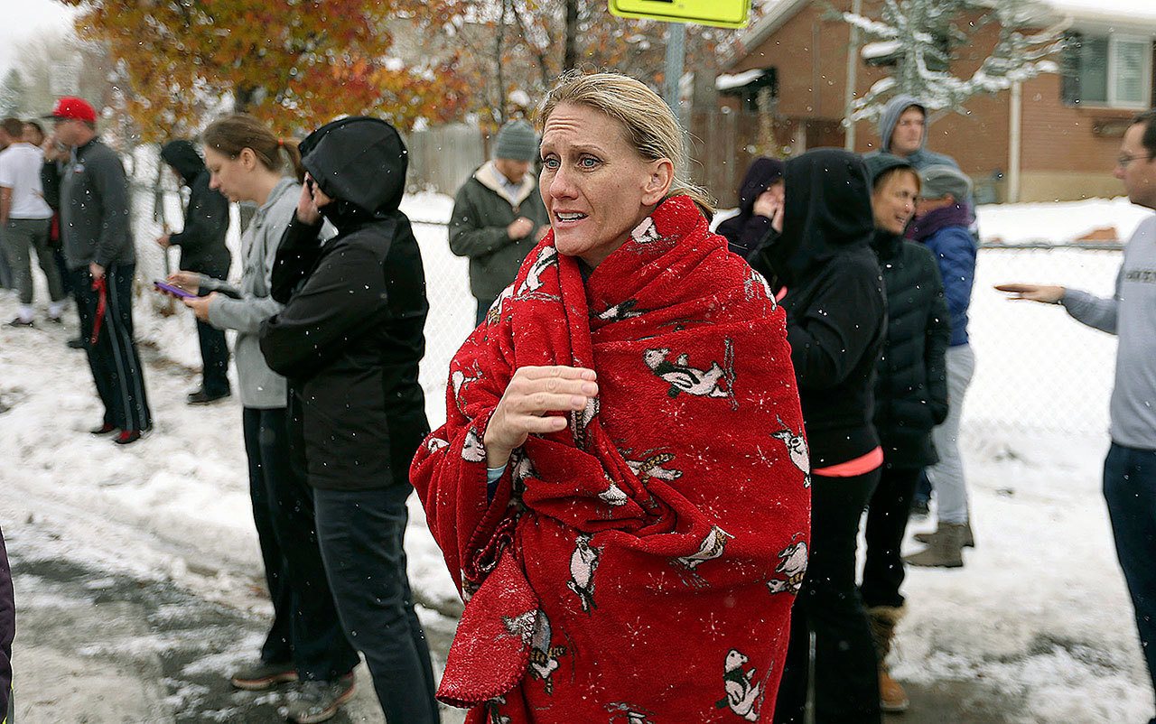 April Williams, who has a child at Mueller Park Junior High School, waits in Bountiful, Utah, on Thursday, Dec. 1, to learn what is happening as officials respond to a gun being fired at the school. Officials said no one is injured after a student fired a gun into the ceiling of the junior high. (Ravell Call/The Deseret News via AP)