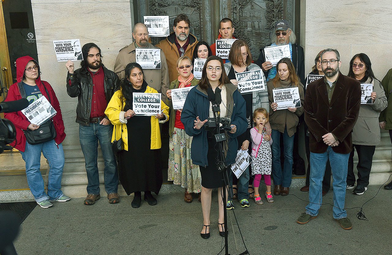 During a news conference in Olympia on Nov. 30, Washington presidential elector Levi Guerra (center) is joined by elector Bret Chiafalo of Everett (second from right) as they announce that they’re asking members of the Electoral College to pick a Republican “consensus candidate” rather than Donald Trump. (Steve Bloom / The Olympian via AP)