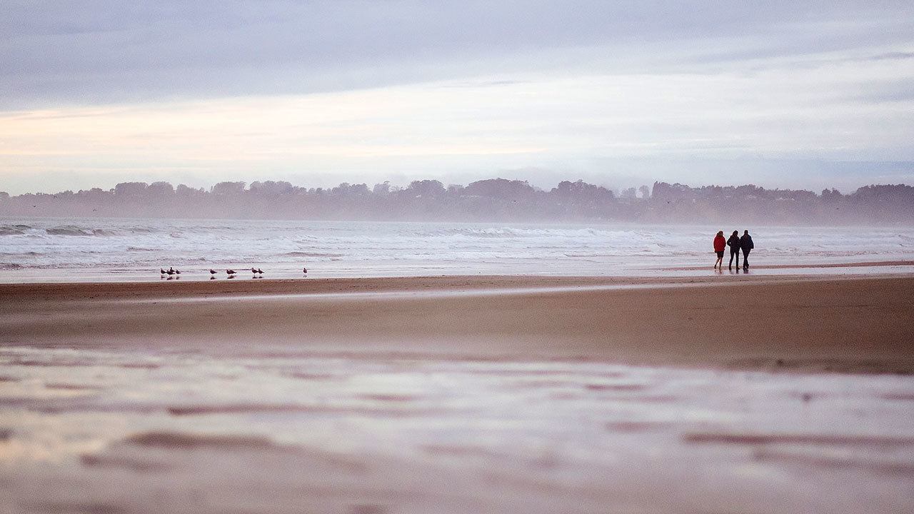 Residents take an afternoon walk along Stinson Beach in Northern California. (Photo for The Washington Post by Ryan Jones)