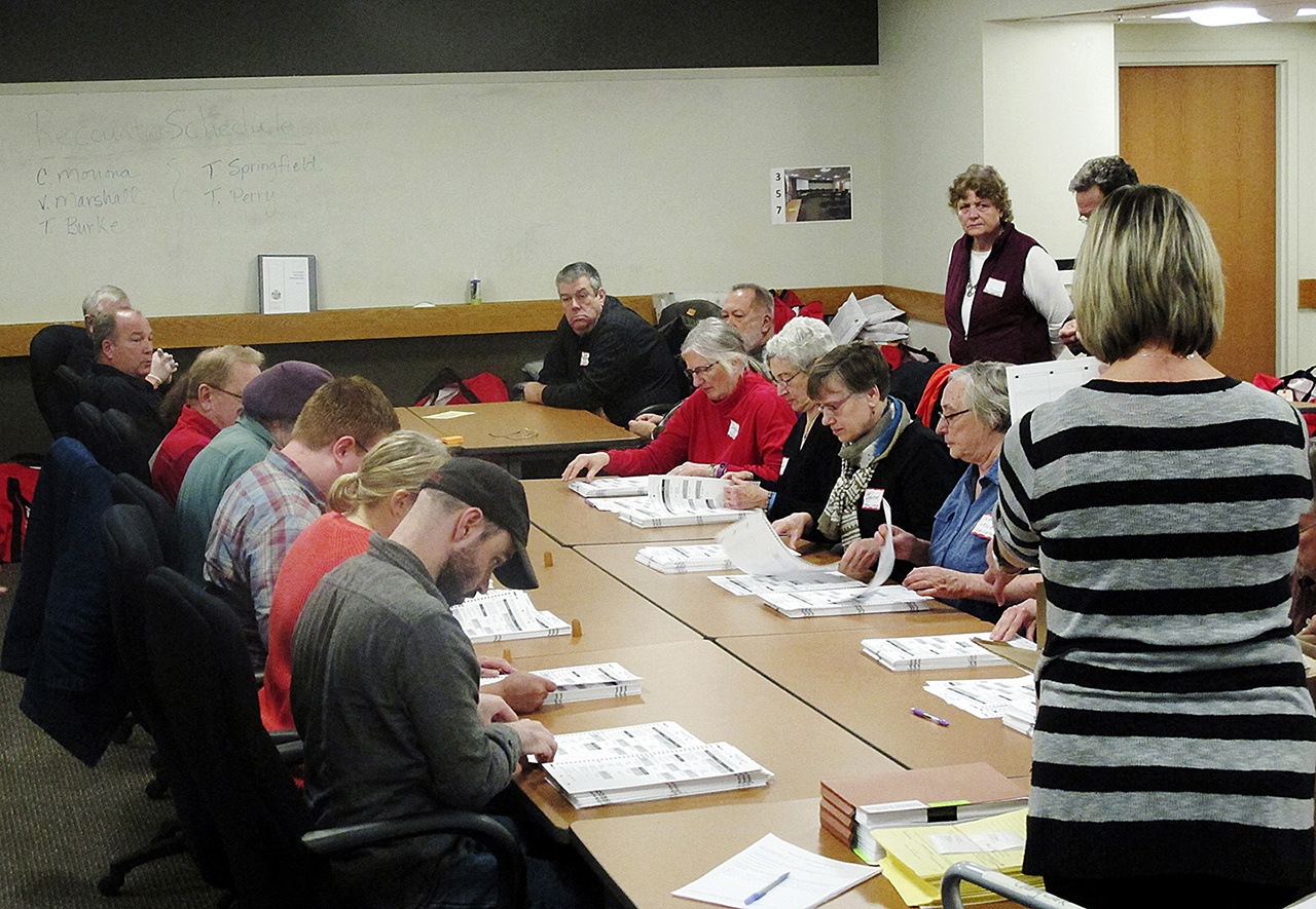 Ballots from the town of Middleton, Wisconsin, are placed in front of workers as a statewide presidential election recount begins, Thursday, Dec. 1, in Madison, Wisconsin. (AP Photo/Scott Bauer)