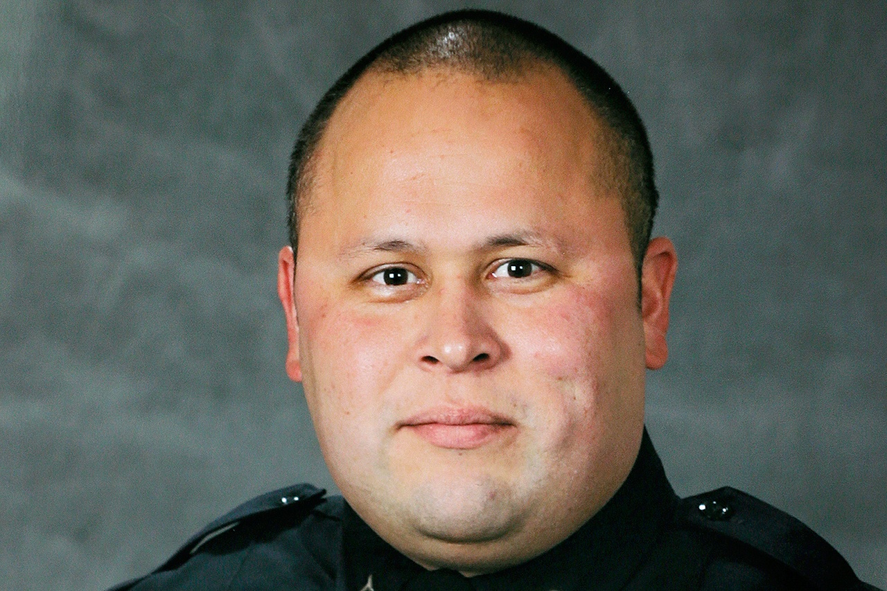 This undated photo provided by the Tacoma Police Department shows officer Reginald “Jake” Gutierrez, who was shot and killed while responding to a domestic dispute call Wednesday in Tacoma. Gutierrez had served with the department since 1999 and was highly respected and experienced, Tacoma Police Chief Donald Ramsdell said Thursday. (Tacoma Police Department via AP)