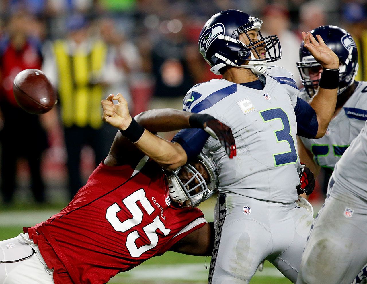 Cardinals linebacker Chandler Jones (55) strips the ball from Seahawks quarterback Russell Wilson (3) during the second half of a game Oct. 23 in Glendale, Ariz. (AP Photo/Ross D. Franklin)