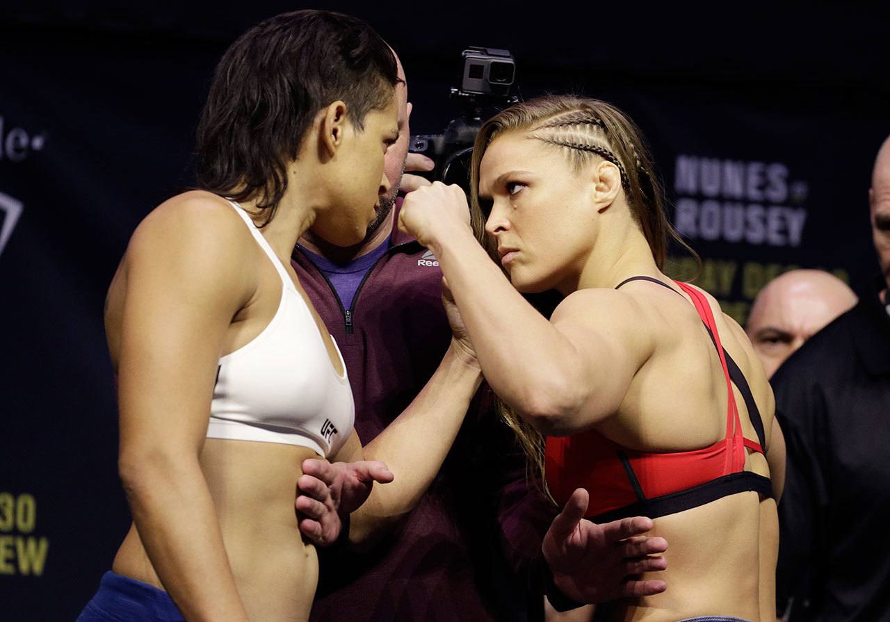Ronda Rousey (right) and Amanda Nunes face off for photographers during an event for UFC 207 on Thursday in Las Vegas. Rousey is scheduled to fight Nunes in a mixed martial arts women’s bantamweight championship bout Saturday in Las Vegas. (AP Photo/John Locher)