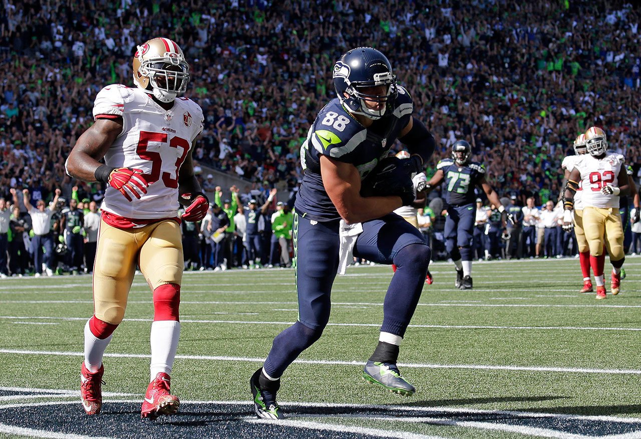 Seahawks tight end Jimmy Graham (88) scores a touchdown in front of 49ers linebacker NaVorro Bowman in the first half of a game Sept. 25 in Seattle. (AP Photo/John Froschauer)