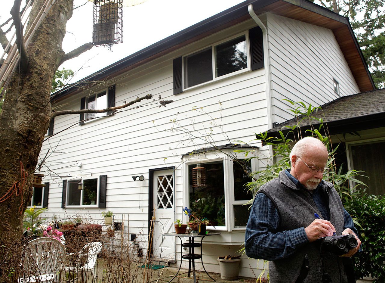 Ecologist and avid bird watcher Alan Mearns takes note of the species and numbers of birds as he spies in his Edmonds back yard in 2012. The 2017 Edmonds Christmas Bird Count is Dec. 17. (Annie Mulligan / Herald file)