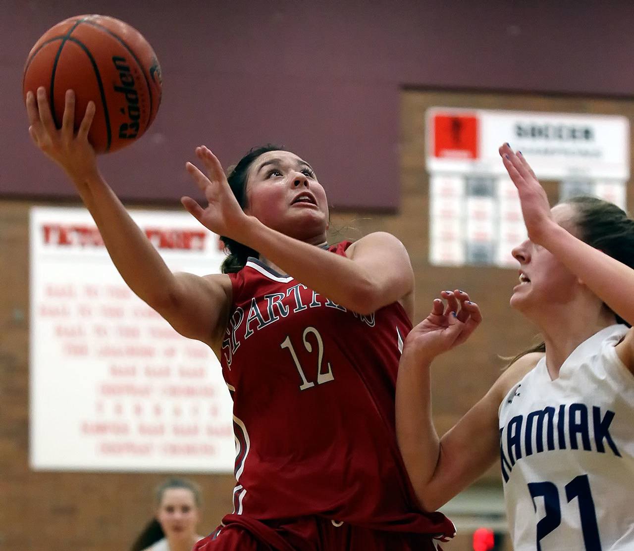 Stanwood’s Kayla Frazier (left) attempts a shot with Kamiak’s Kate Huguenin defending during the Mountlake Terrace Holiday Tournament Friday night at Mountlake Terrace High School. (Kevin Clark / The Herald)