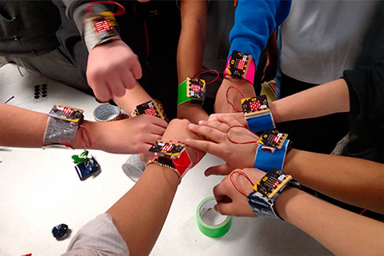 Eisenhower Middle School students show the micro:bits they’ve created using technology received from Microsoft’s educational outreach program. (Contributed photo)