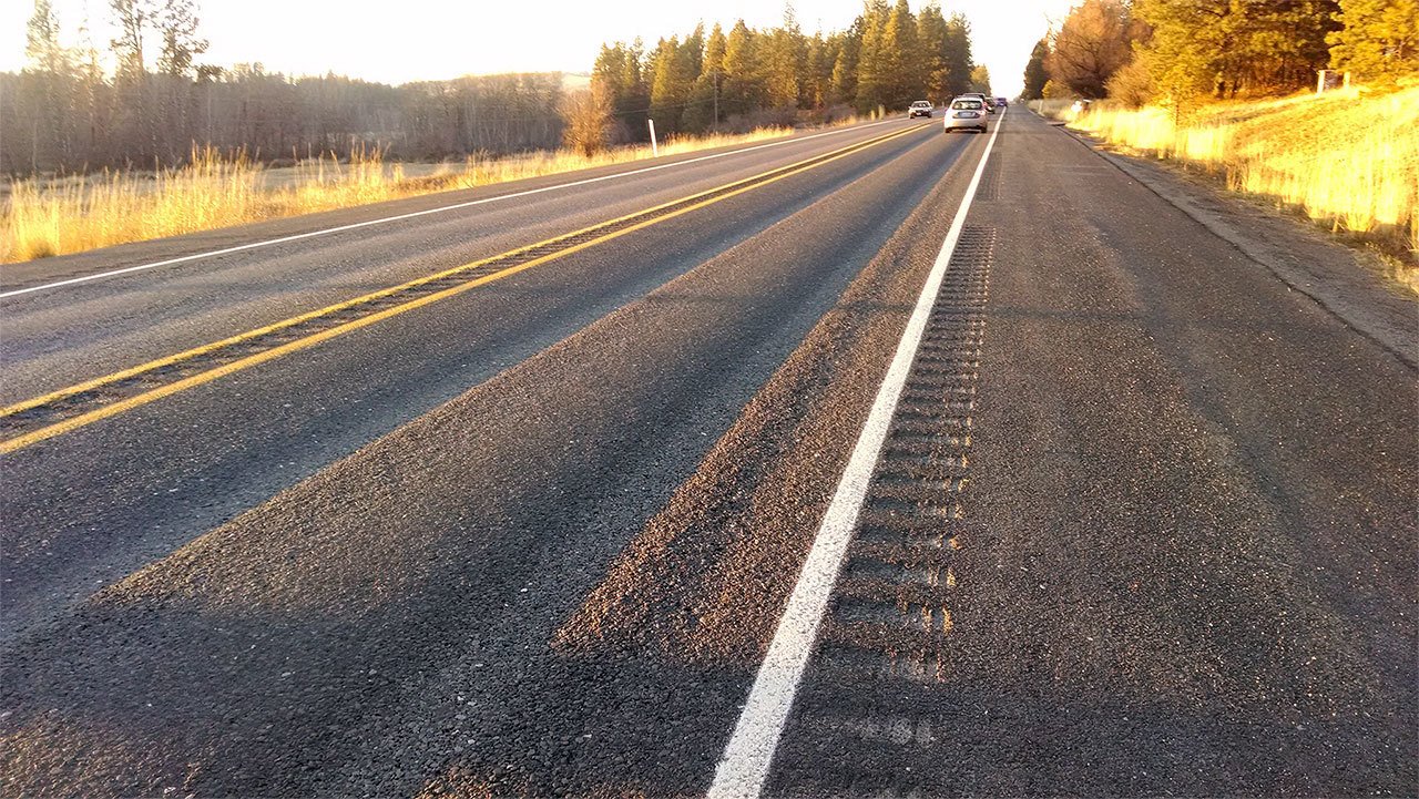 Highway 904 north of Cheney shows 15 years of wear caused primarily by studded tires. State agencies continue to try to ban the tires. So far, they’ve succeeded only in adding a new $5 fee per new studded tire to help address the damage. (WSDOT photo)