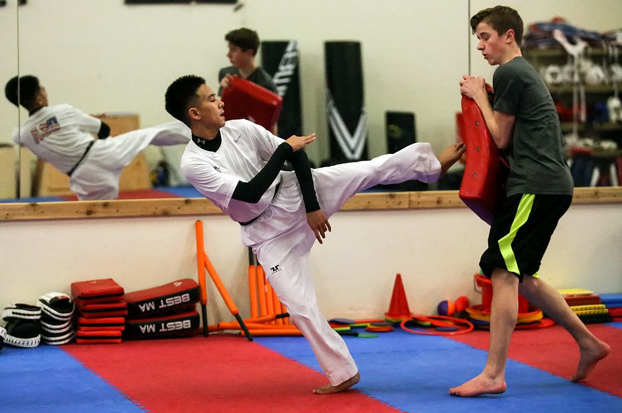 Balil Hasan, 15, sophomore at Kamiak High School works out at Lee’s Martial Arts Academy Thursday night in Lynnwood on December 2, 2016. Hasan is a member of the USA Taekwondo Junior National Team and recently competed at the World Junior Championships in Canada. (Kevin Clark / The Herald)