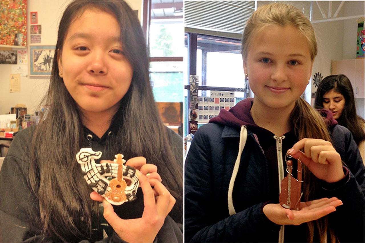 Jasmine Tran (left photo) and Serafima Ermokhina display the ornaments they made that now hang on the Christmas tree at the governor’s mansion in Olympia. Students in teacher Mari Atkinson’s art class at Olympic View Middle School were selected to help with this year’s decorations. (Contributed photo)